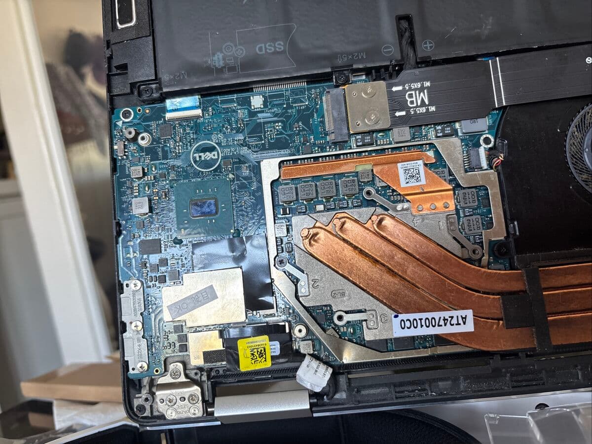 Dell laptop motherboard repair showing heatsink and components